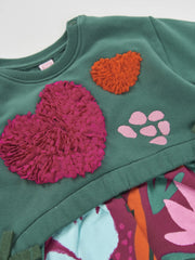 Closer look at the Tuc Tuc combined dress showing detail of the tulle heart appliqués.
