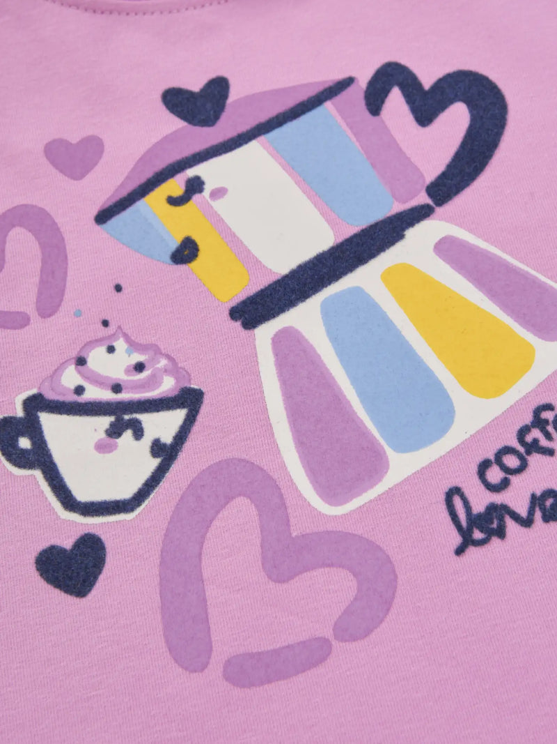 Closer look at the pink top showing detail of the coffee themed print.