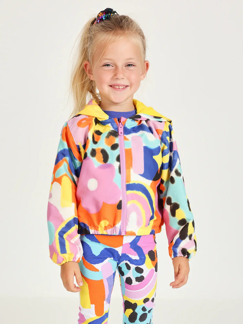 Smiling Girl modelling the Tuc Tuc floral print jacket.