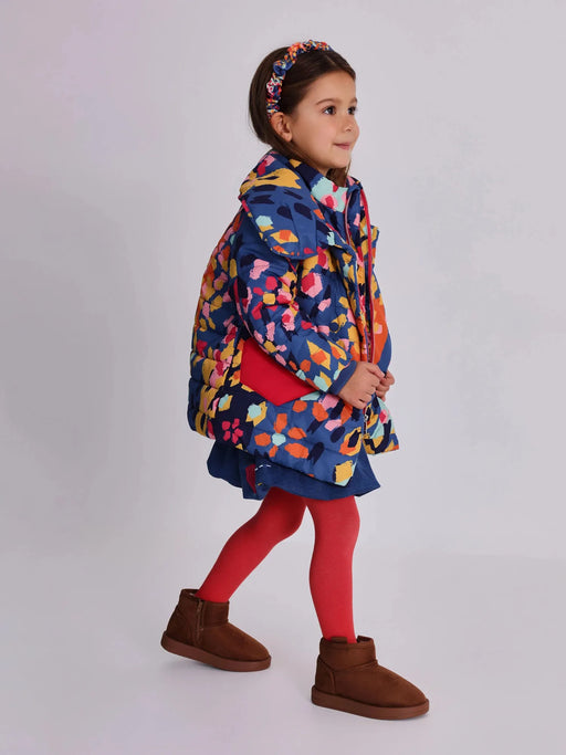 Girl wearing the Tuc Tuc patterned coat.