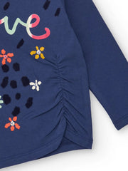 Closer view of the girl's long sleeve top.