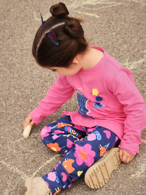 Girl in pink printed leggings set by Tuc Tuc.