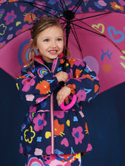 Smiling Girl modelling the Tuc Tuc printed raincoat.