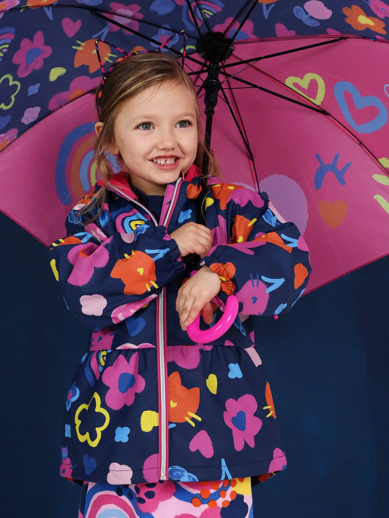 Smiling Girl modelling the Tuc Tuc printed raincoat.