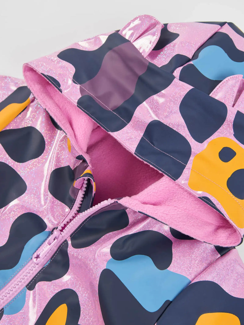 Closer look at the Tuc Tuc printed raincoat showing detail of the sparkling glitter finish.
