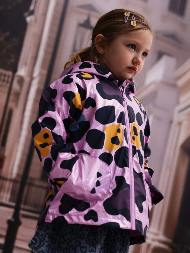 Girl wearing the Tuc Tuc printed raincoat.
