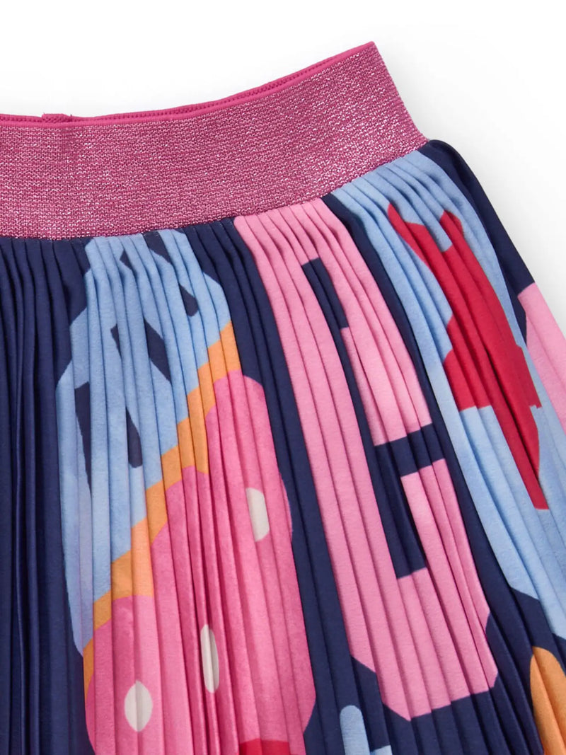 Girl's pleated skirt with abstract print pattern.