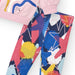 Girl's full length leggings, printed with colourful stars and paint splotches. 