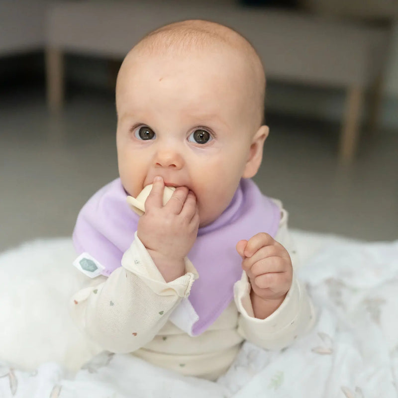 Baby girl wearing a lilac Ziggle bandana bib.