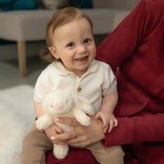Smiling baby boy holding the Ziggle plush bunny.