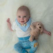 Smiling baby boy holding the Ziggle plush puppy.