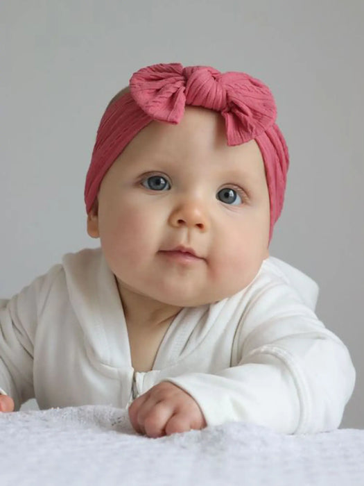 Baby girl wearing the Ziggle Raspberry Headband.