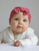 Baby girl wearing the Ziggle Raspberry Headband.