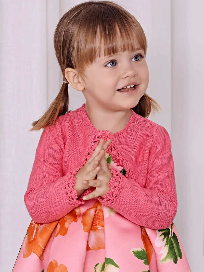 Baby girl modelling the Abel and Lula bolero cardigan.