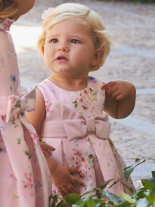 Baby girl modelling the Abel and Lula floral print dress.