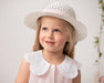 Smiling girl modelling the Caramelo bow hat.