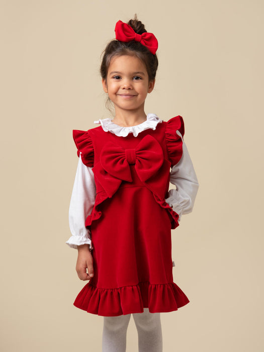 Girl wearing the Caramelo velour dress.