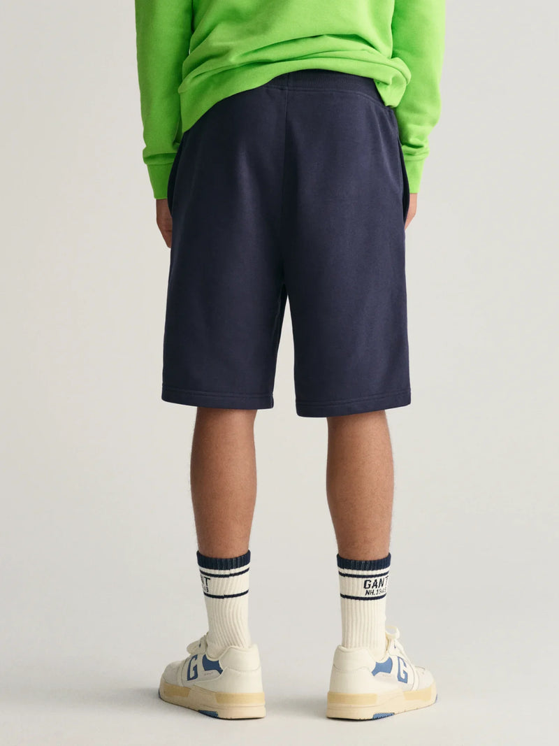 Back of the GANT navy shield track shorts.