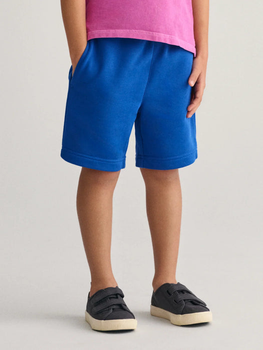Boy wearing the GANT shield track shorts.