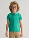 Baby boy modelling the GANT sunfaded polo shirt.