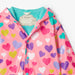 Closer view of the colour changing pattern on the Hatley colourful hearts raincoat.