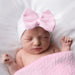 Sleeping baby wearing the Newborn Baby's Bow Hat - White & Pink