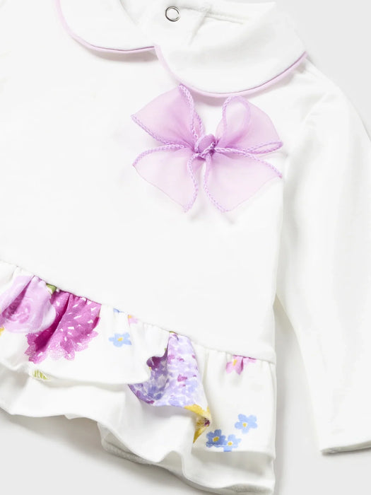 Baby girl's white top with lilac bow.