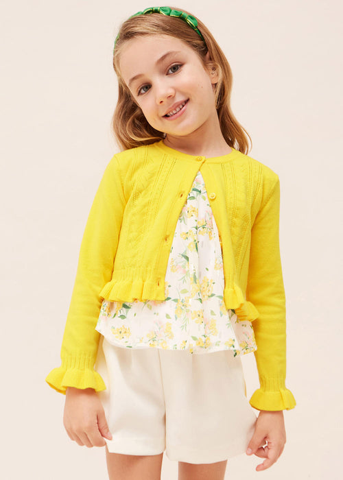 Girl wearing the Mayoral frilled cardigan.