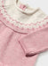 Newborn girl's pink knitted top.