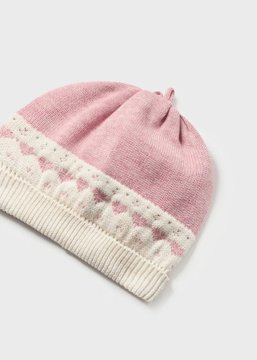Newborn girl's pink and white knitted hat.