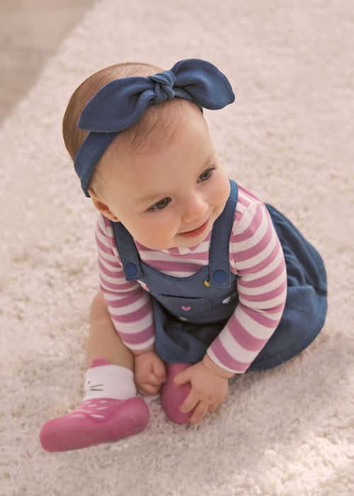 Baby girl wearing the Mayoral blue bow headband.
