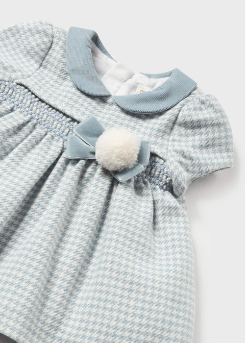 Baby girl's dress with faux fur pom pom.