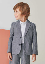 Smiling boy modelling the Mayoral linen jacket.