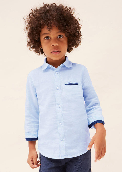 Boy modelling the Mayoral light blue linen shirt.