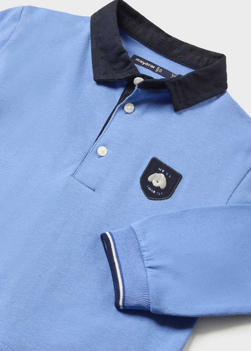 Baby boy's blue polo shirt with navy logo crest.
