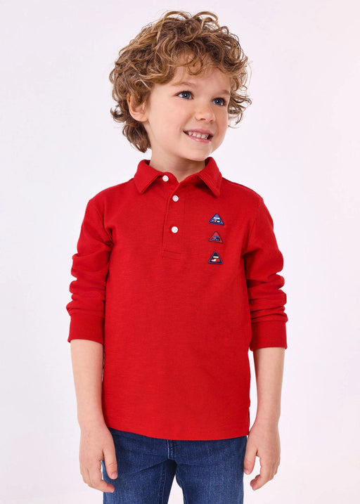 Boy modelling the Mayoral long sleeve polo shirt.