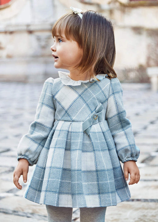 Baby girl wearing the Mayoral plaid dress.