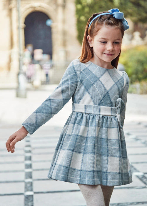 Girl modelling the Mayoral plaid dress.