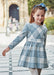 Girl modelling the Mayoral plaid dress.