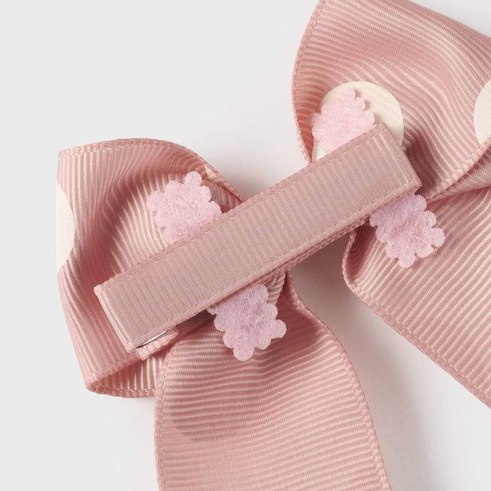 Closer look at the Mayoral blush pink polka dot bow clip.
