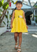 Girl modelling the Mayoral sunny yellow sleeveless dress.