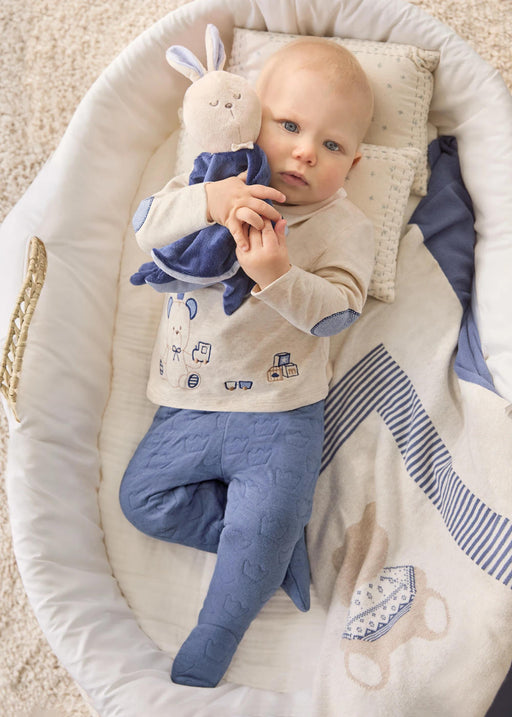 Baby boy in a cot wearing the two piece leg warmer set.