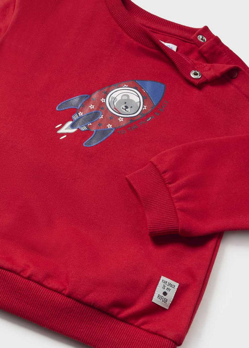 Baby boy's red top with cute rocket ship design.