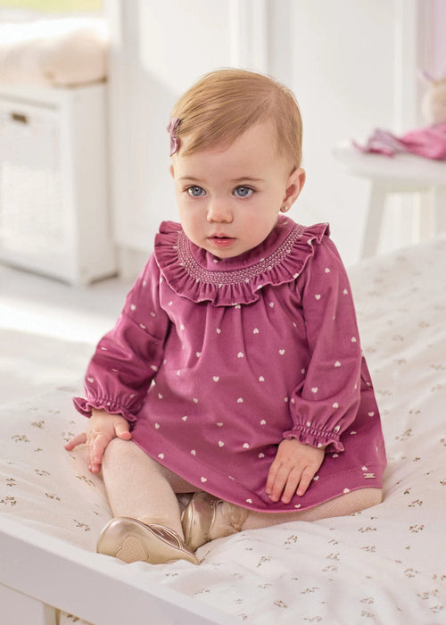 Baby girl wearing the Mayoral velvet dress.