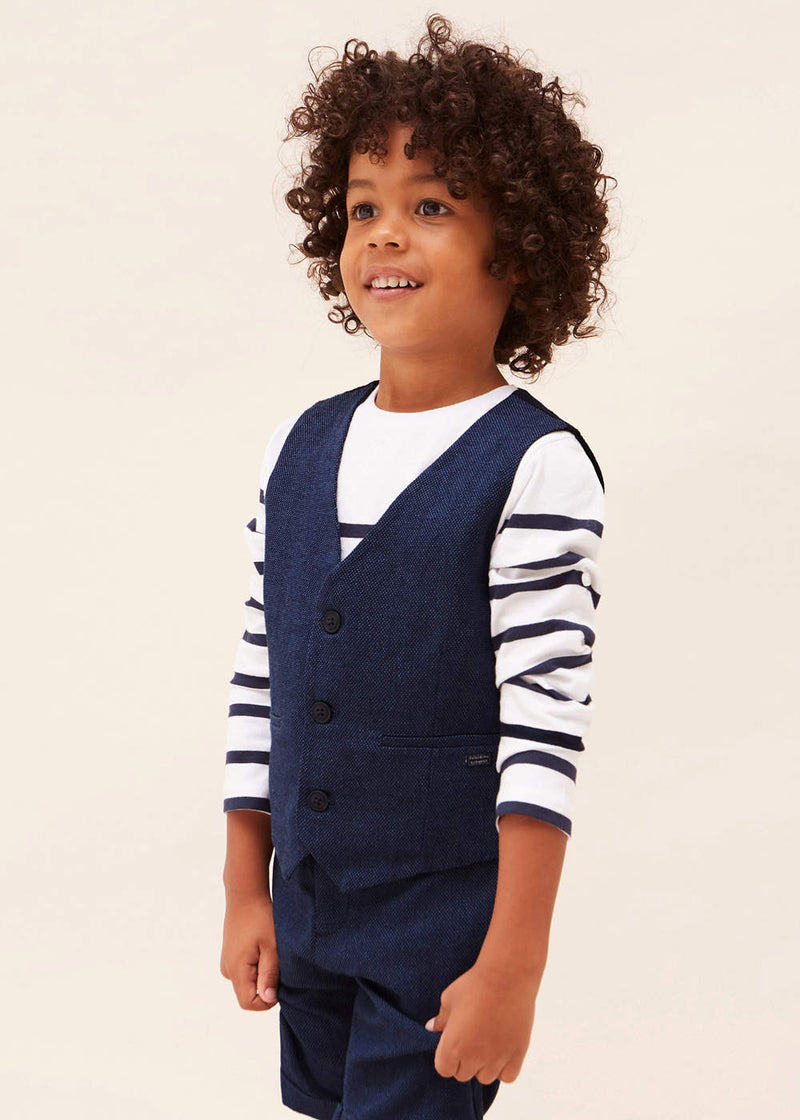 Smiling boy modelling the Mayoral waistcoat.