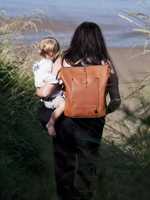 Woman wearing the Pacapod Saunton Changing Bag as a backpack