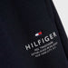 Closer look at the Tommy Hilfiger navy logo track bottoms.