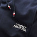 Closer look at the Tommy Hilfiger navy logo track bottoms.