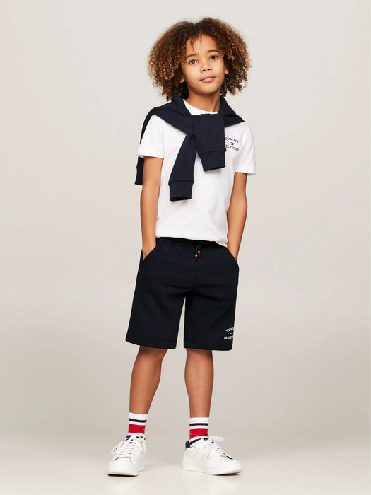 Boy wearing the Tommy Hilfiger logo track shorts.