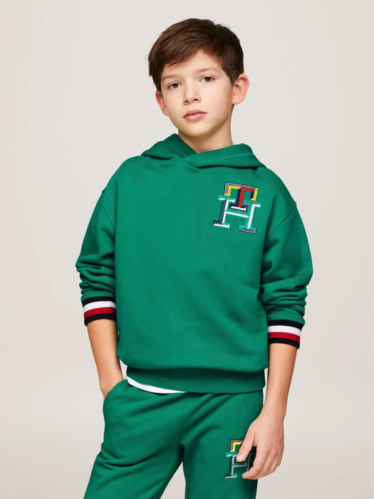 Boy modelling the Tommy Hilfiger monogram hoodie.